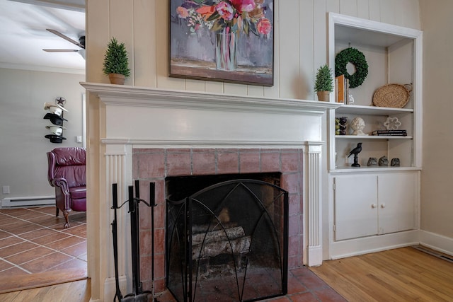 3011 Fox Spring Rd, Augusta, GA 30909 - detailed view of a tile fireplace, a baseboard radiator, a ceiling fan, wood finished floors, and ornamental molding