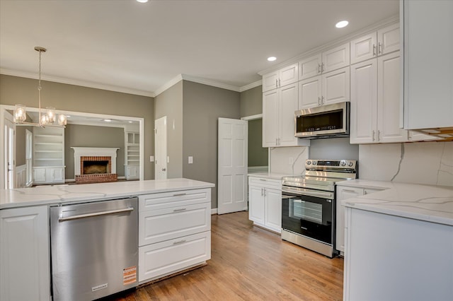 4 Shadowmoor Ct, North Augusta, SC 29841 - kitchen with stainless steel appliances, ornamental molding, white cabinets, light wood finished floors, and recessed lighting