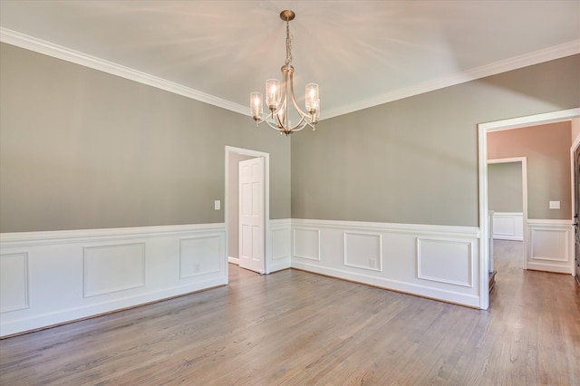 4 Shadowmoor Ct, North Augusta, SC 29841 - empty room with a chandelier, crown molding, wood finished floors, wainscoting, and a decorative wall