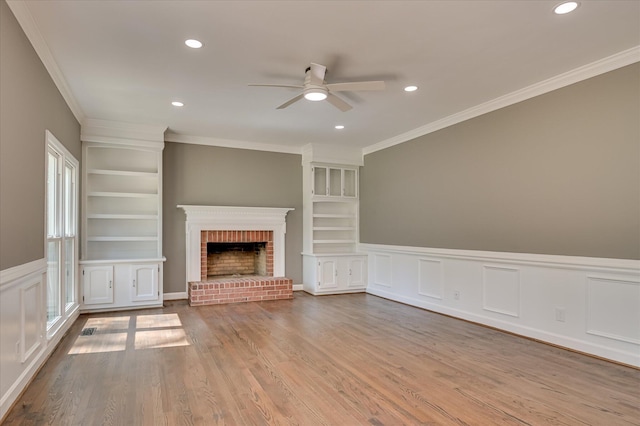4 Shadowmoor Ct, North Augusta, SC 29841 - unfurnished living room with ceiling fan, crown molding, built in shelves, a brick fireplace, and wood finished floors