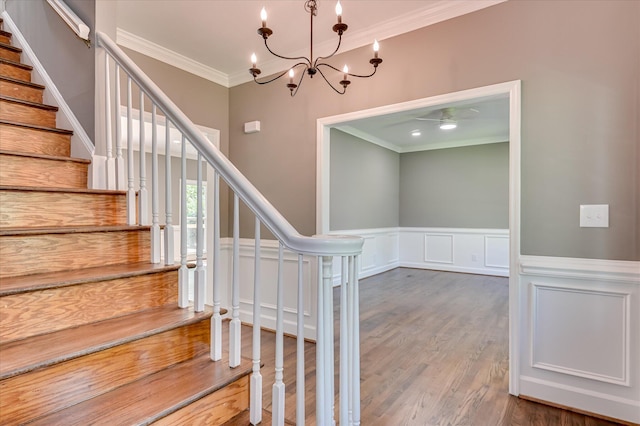 4 Shadowmoor Ct, North Augusta, SC 29841 - stairs featuring crown molding, a chandelier, wood finished floors, a decorative wall, and ceiling fan
