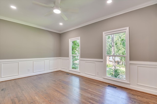 4 Shadowmoor Ct, North Augusta, SC 29841 - spare room featuring healthy amount of natural light, wainscoting, wood finished floors, a ceiling fan, and crown molding