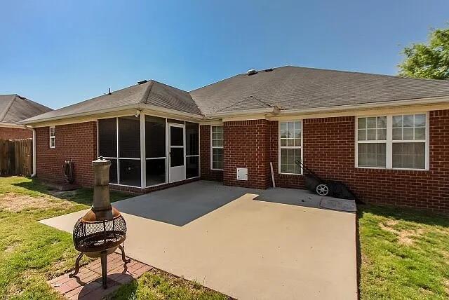 507 Julia Ct, Grovetown, GA 30813 - back of house with a patio, brick siding, a sunroom, and a fire pit