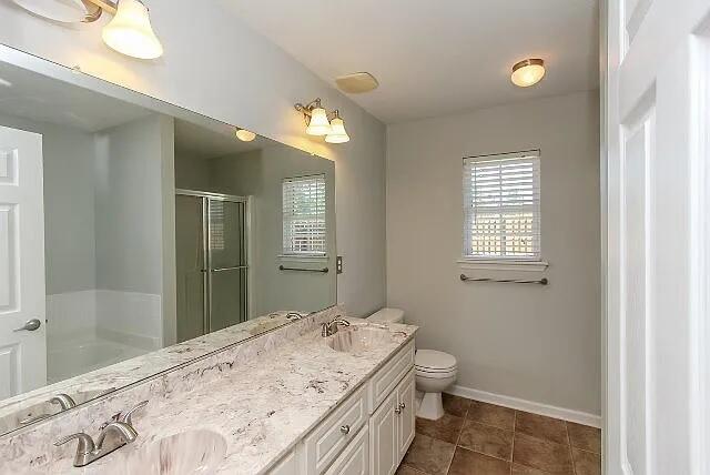 507 Julia Ct, Grovetown, GA 30813 - bathroom with a stall shower, double vanity, baseboards, a garden tub, and toilet