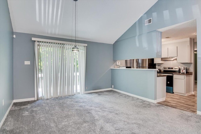 kitchen featuring pendant lighting, high vaulted ceiling, stainless steel electric stove, light colored carpet, and white cabinetry