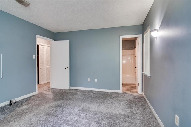 unfurnished bedroom featuring carpet flooring and a textured ceiling