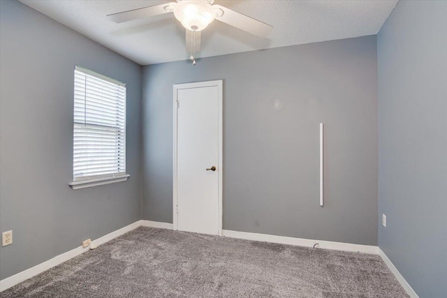 unfurnished room featuring carpet, ceiling fan, and a textured ceiling