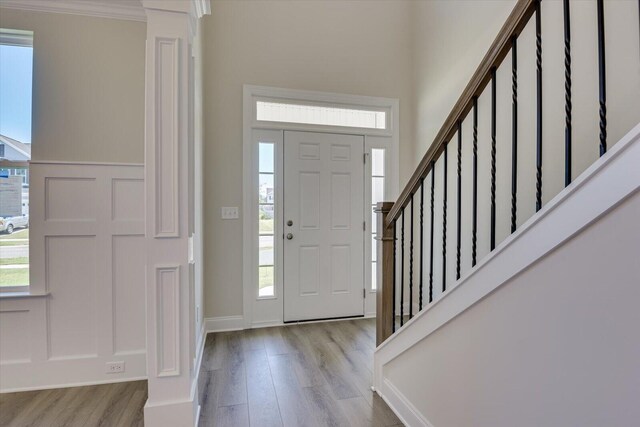 entryway featuring crown molding and light hardwood / wood-style flooring