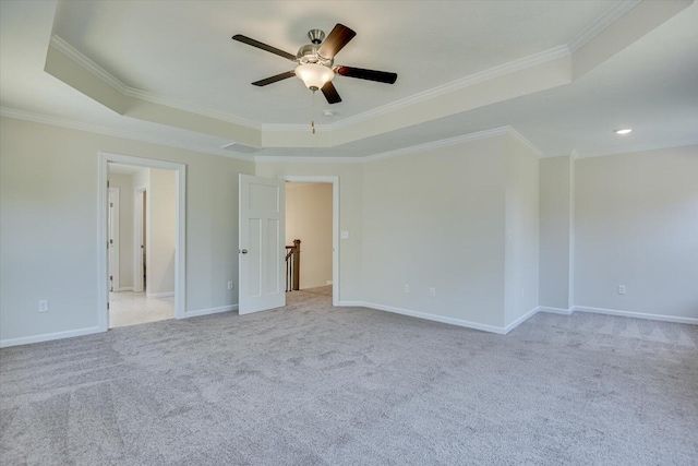 unfurnished room featuring ornamental molding and a tray ceiling