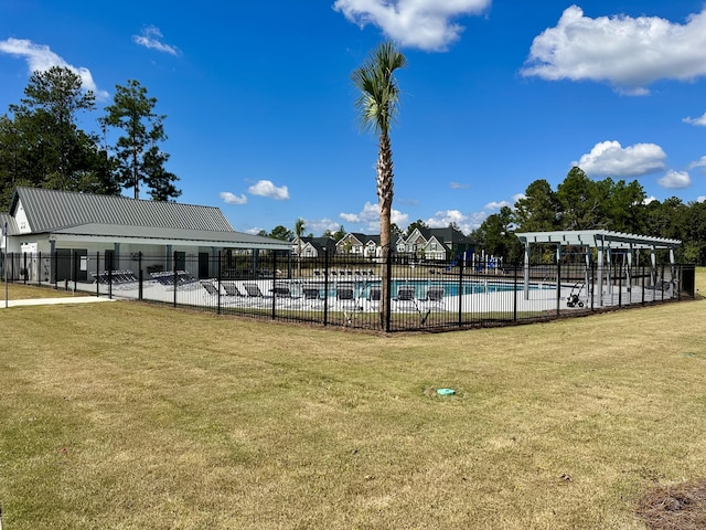 pool featuring a yard, fence, and a pergola