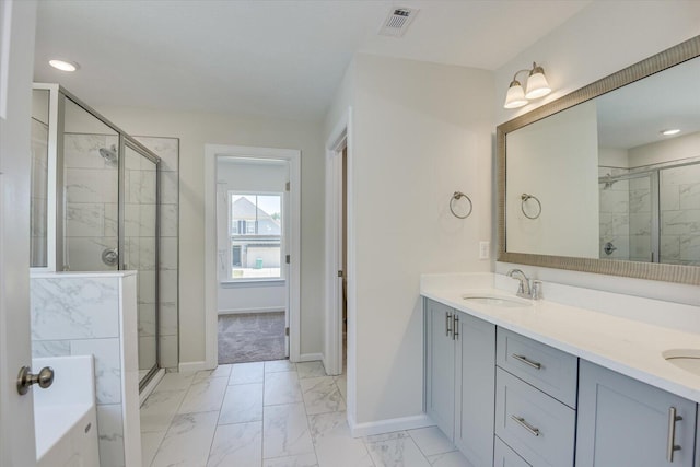 bathroom with a stall shower, marble finish floor, visible vents, and a sink