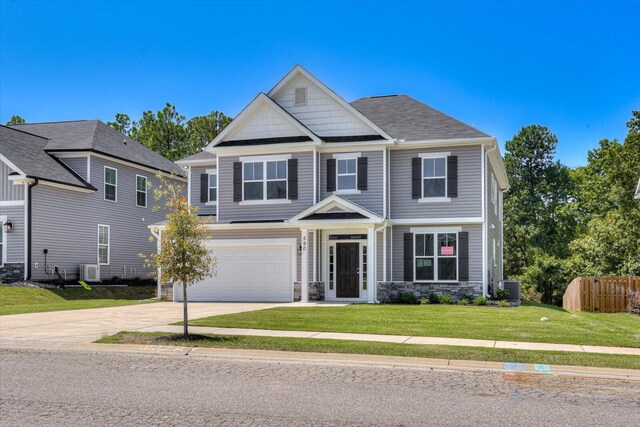 craftsman inspired home featuring central AC, a front yard, and a garage