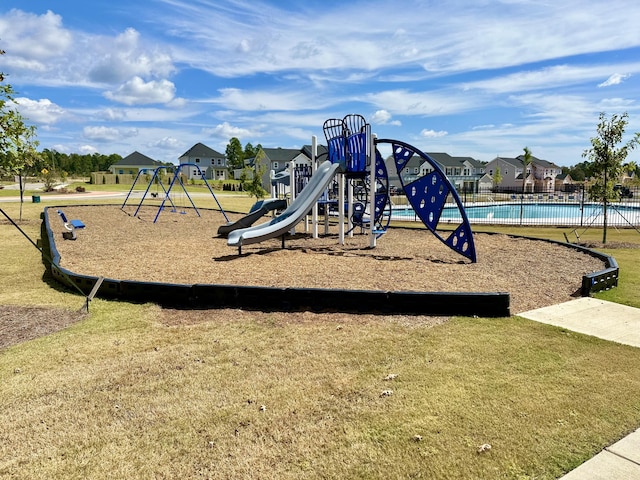 view of jungle gym featuring a lawn