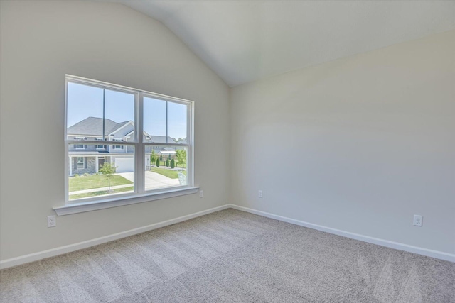 unfurnished room featuring carpet flooring and lofted ceiling