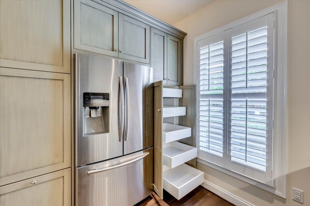 kitchen featuring gray cabinetry, stainless steel fridge with ice dispenser, and dark wood-type flooring