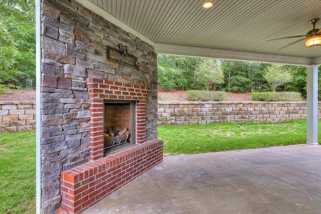 view of patio / terrace featuring an outdoor brick fireplace and ceiling fan