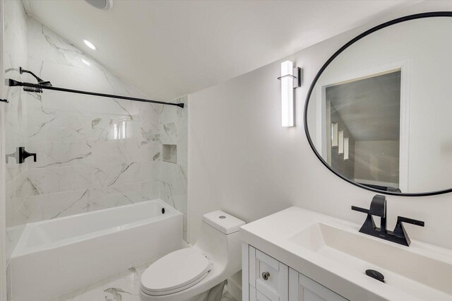 full bathroom with lofted ceiling, vanity, tiled shower / bath combo, and toilet