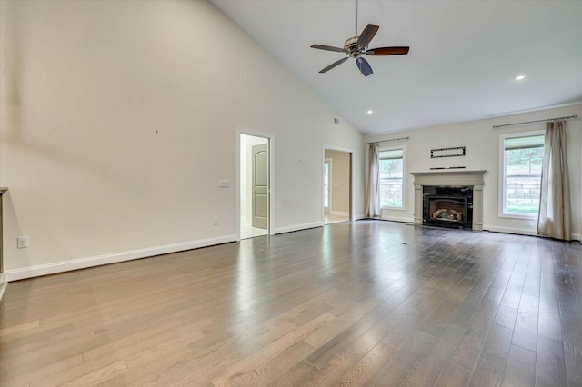 unfurnished living room with ceiling fan, light hardwood / wood-style floors, and high vaulted ceiling