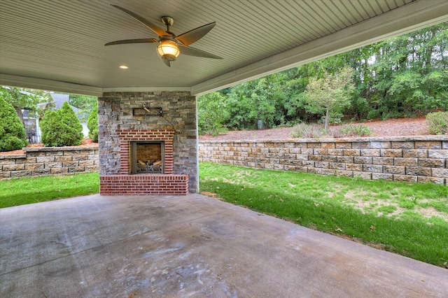 view of patio / terrace featuring an outdoor brick fireplace and ceiling fan