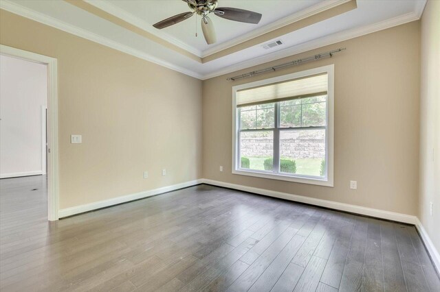 spare room with a raised ceiling, ceiling fan, crown molding, and light hardwood / wood-style floors