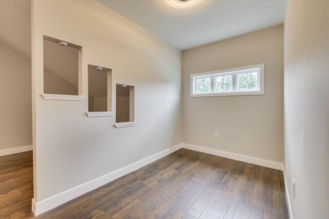 spare room with dark hardwood / wood-style flooring