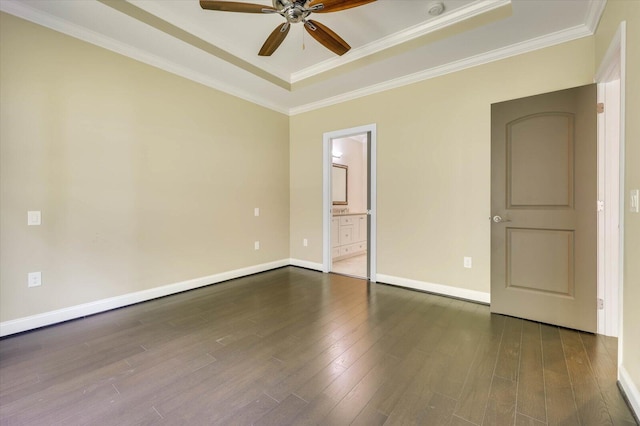 unfurnished room with dark hardwood / wood-style flooring, a raised ceiling, ceiling fan, and crown molding