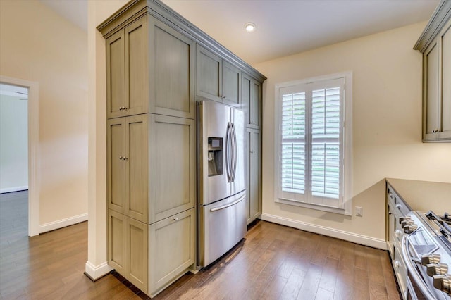 kitchen featuring stainless steel appliances, dark wood-type flooring, and gray cabinetry