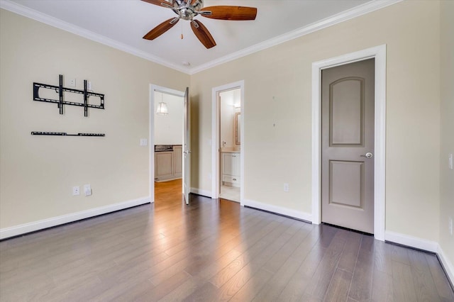 spare room featuring dark hardwood / wood-style floors, ceiling fan, and crown molding