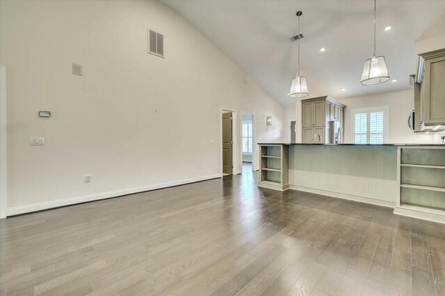 unfurnished living room featuring hardwood / wood-style flooring and high vaulted ceiling