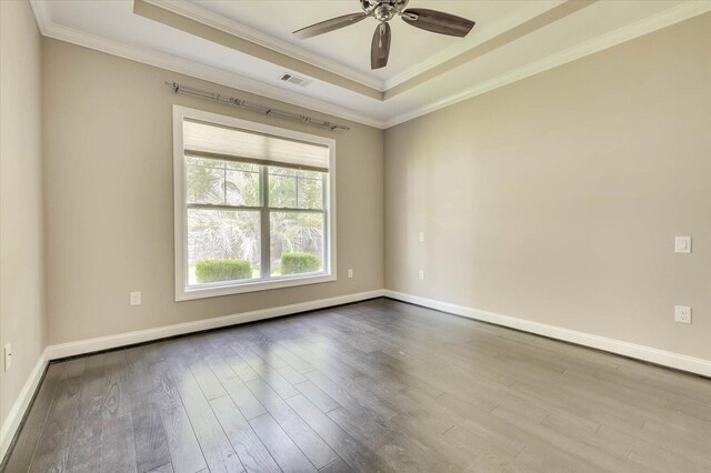 spare room featuring ceiling fan, light hardwood / wood-style floors, a raised ceiling, and ornamental molding