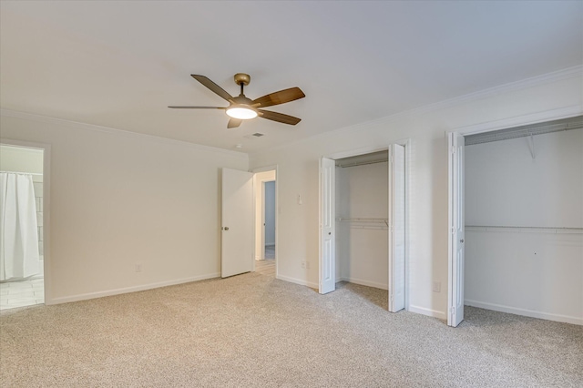 715 Gentlewind Ln, Martinez, GA 30907 - unfurnished bedroom featuring two closets, ornamental molding, carpet flooring, and a ceiling fan