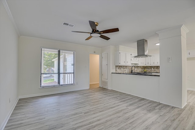715 Gentlewind Ln, Martinez, GA 30907 - unfurnished living room featuring light wood-style flooring, ornamental molding, and a ceiling fan