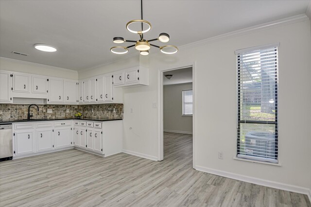 715 Gentlewind Ln, Martinez, GA 30907 - kitchen with dark countertops, a chandelier, backsplash, white cabinetry, and ornamental molding