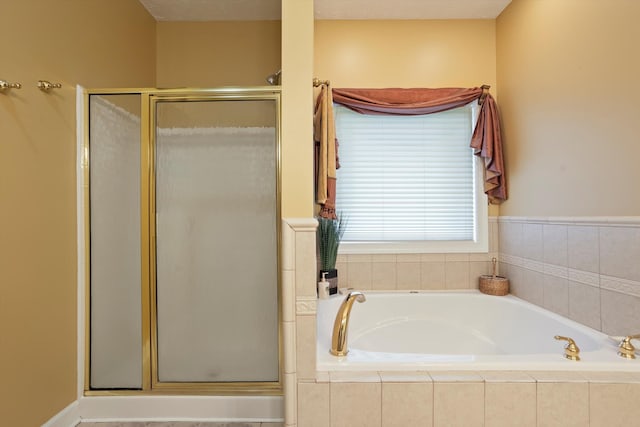 bathroom featuring separate shower and tub