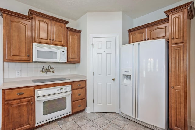 kitchen with decorative backsplash and white appliances