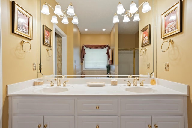 bathroom featuring walk in shower, vanity, and an inviting chandelier