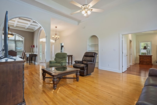 living room featuring beamed ceiling, light hardwood / wood-style floors, crown molding, and coffered ceiling