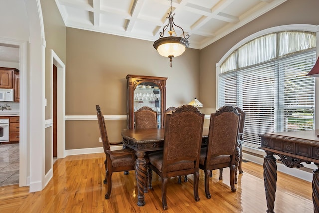 dining room with beamed ceiling, light hardwood / wood-style flooring, and coffered ceiling