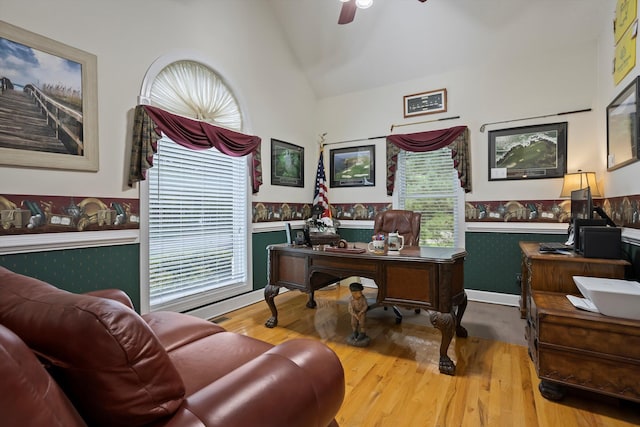 office area featuring hardwood / wood-style flooring, ceiling fan, a healthy amount of sunlight, and vaulted ceiling