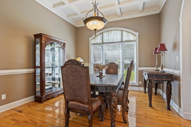 dining room featuring light hardwood / wood-style floors, a wealth of natural light, and coffered ceiling