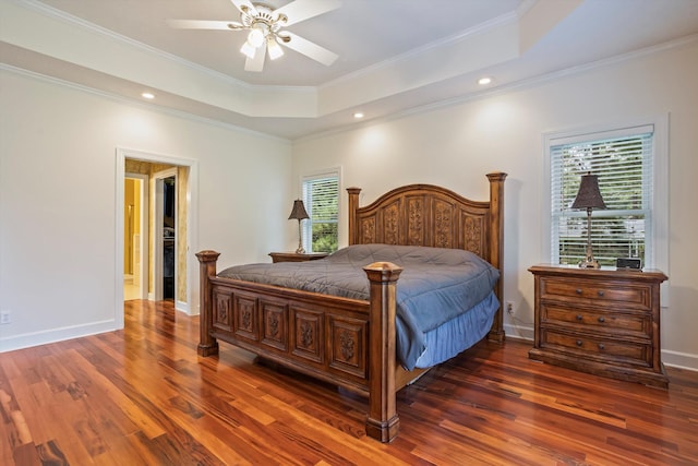 bedroom with ceiling fan, ornamental molding, multiple windows, and a tray ceiling