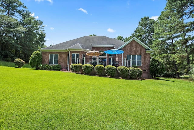 rear view of house with a yard