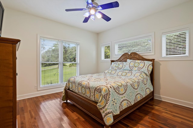 bedroom with ceiling fan and dark wood-type flooring