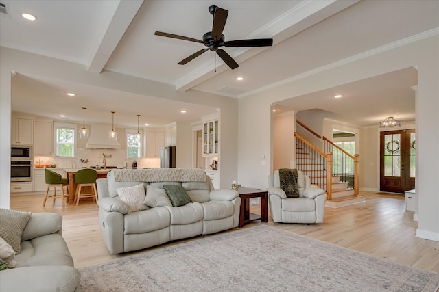 living area featuring recessed lighting, stairway, and light wood finished floors
