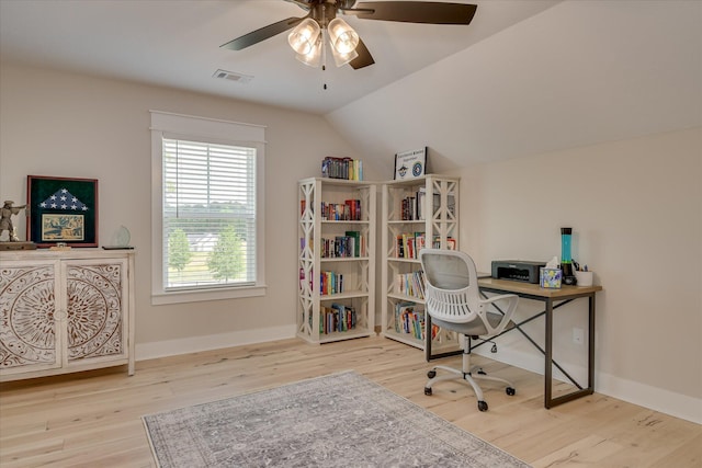 office area featuring ceiling fan, vaulted ceiling, wood finished floors, and visible vents