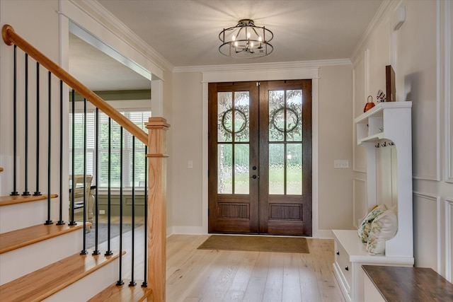 entryway featuring plenty of natural light, french doors, and light wood-style floors
