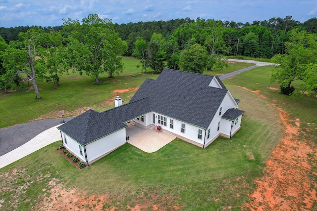 drone / aerial view featuring a forest view