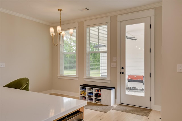 dining area with visible vents, ornamental molding, baseboards, light wood finished floors, and a notable chandelier