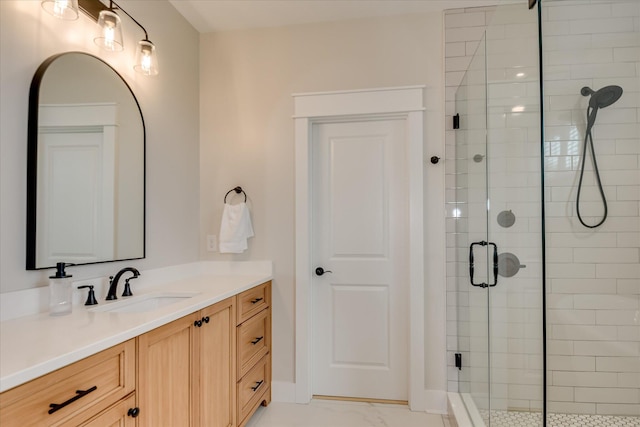 bathroom with vanity, marble finish floor, and a shower stall