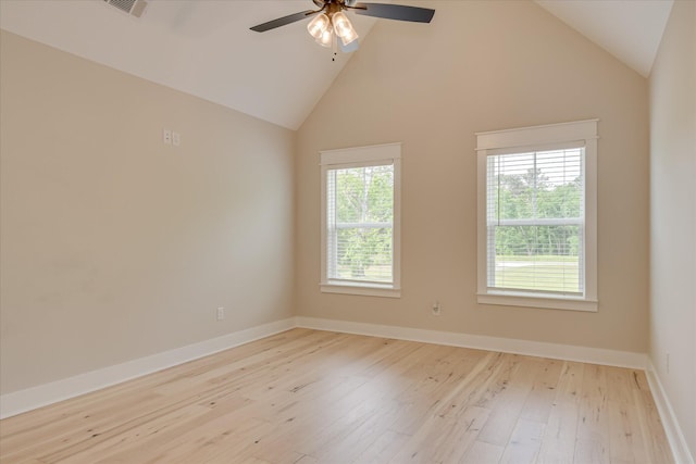 spare room featuring baseboards, a ceiling fan, high vaulted ceiling, and hardwood / wood-style floors